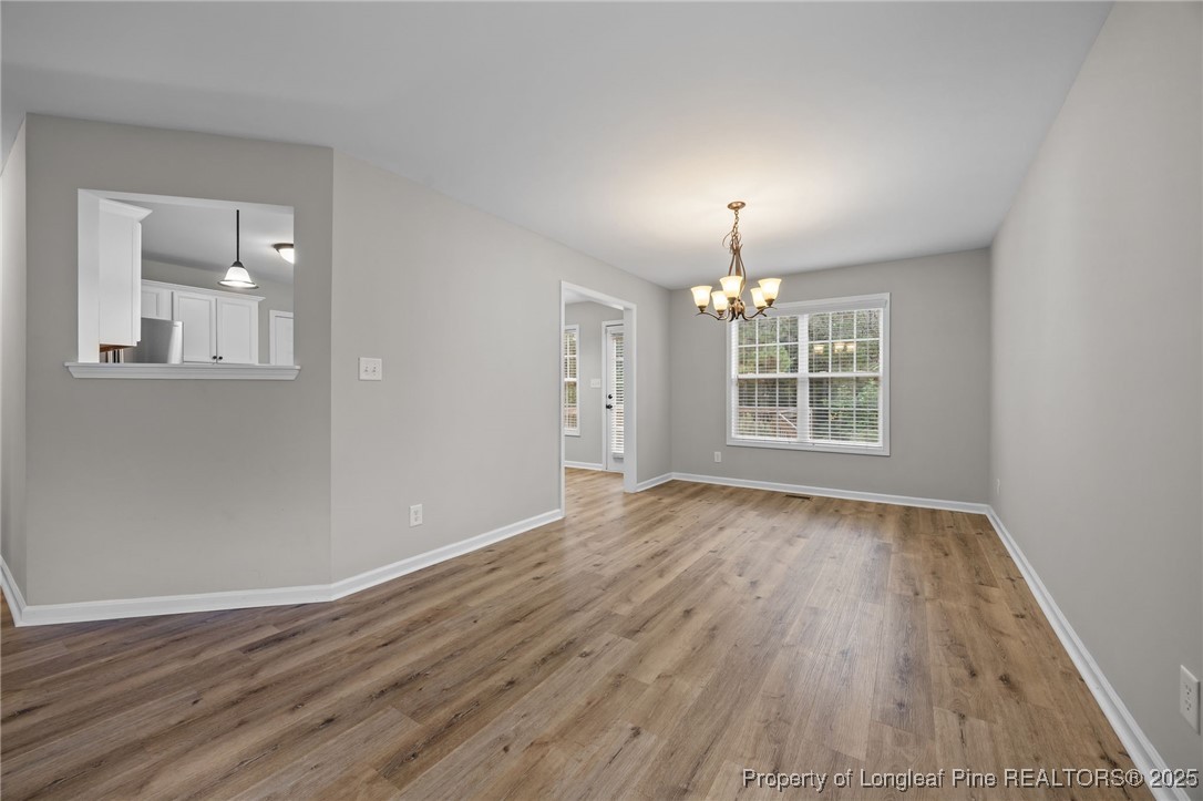 216 Cobblestone Drive Spring Lake, NC 28390 - Photo 25 of 38 wooden floor in an empty room with a window