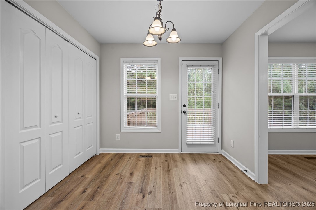 216 Cobblestone Drive Spring Lake, NC 28390 - Photo 28 of 38 an empty room with wooden floor cabinet and windows
