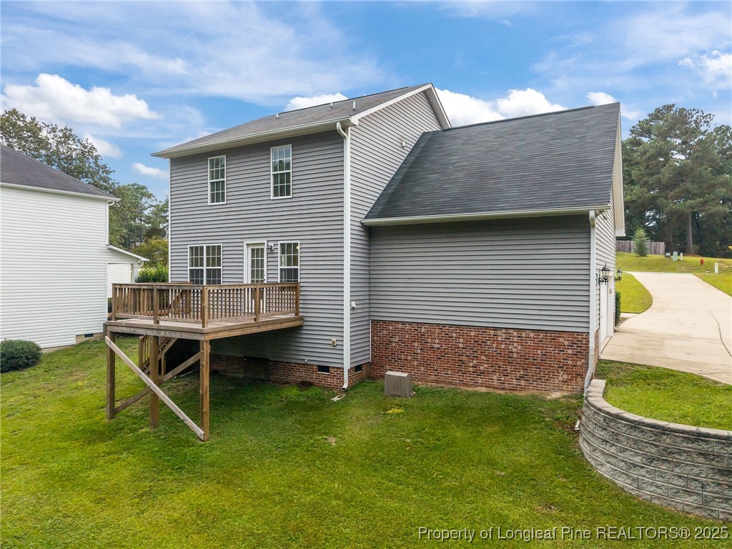 216 Cobblestone Drive Spring Lake, NC 28390 - Photo 5 of 38 a backyard of a house with table and chairs