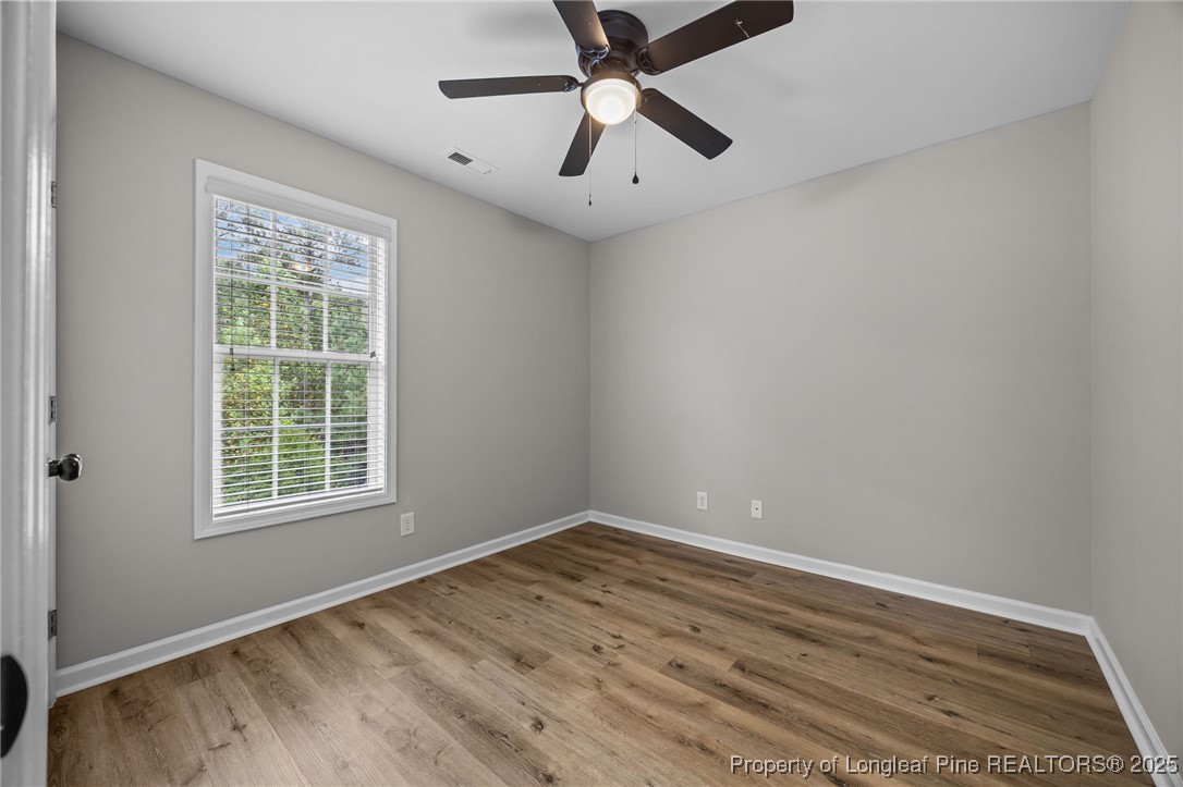 216 Cobblestone Drive Spring Lake, NC 28390 - Photo 7 of 38 a view of empty room with wooden floor and fan