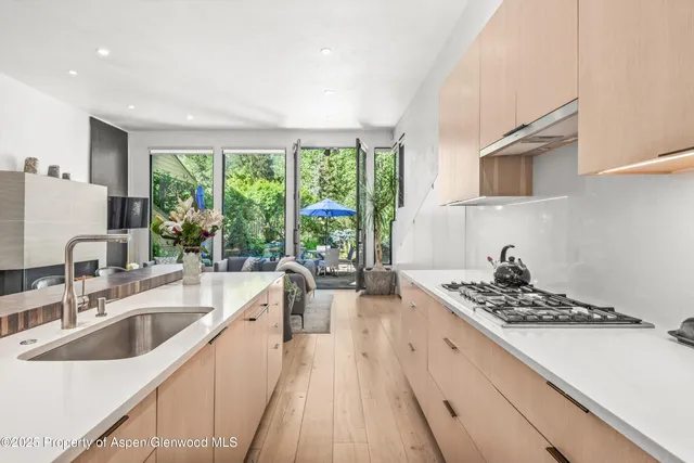 a kitchen with a sink stove top oven and cabinets