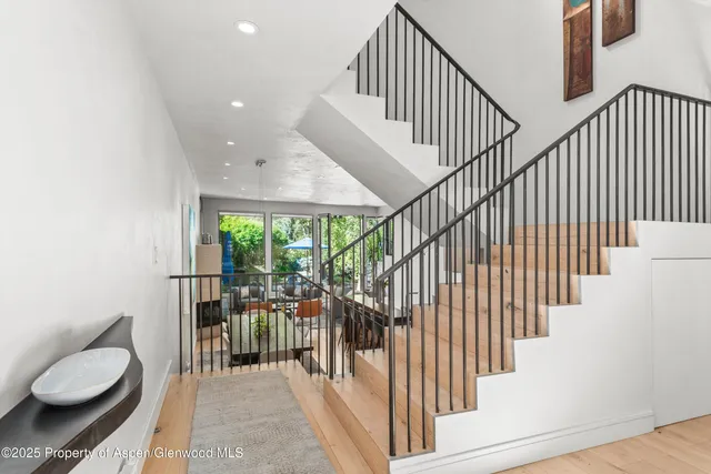 a view of entryway and hall with wooden floor
