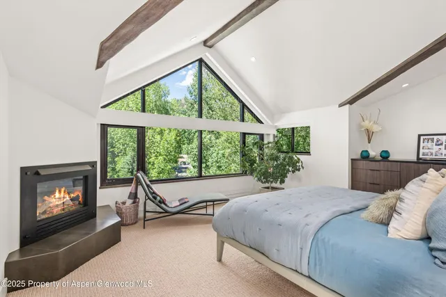 a bedroom with a bed and a fireplace