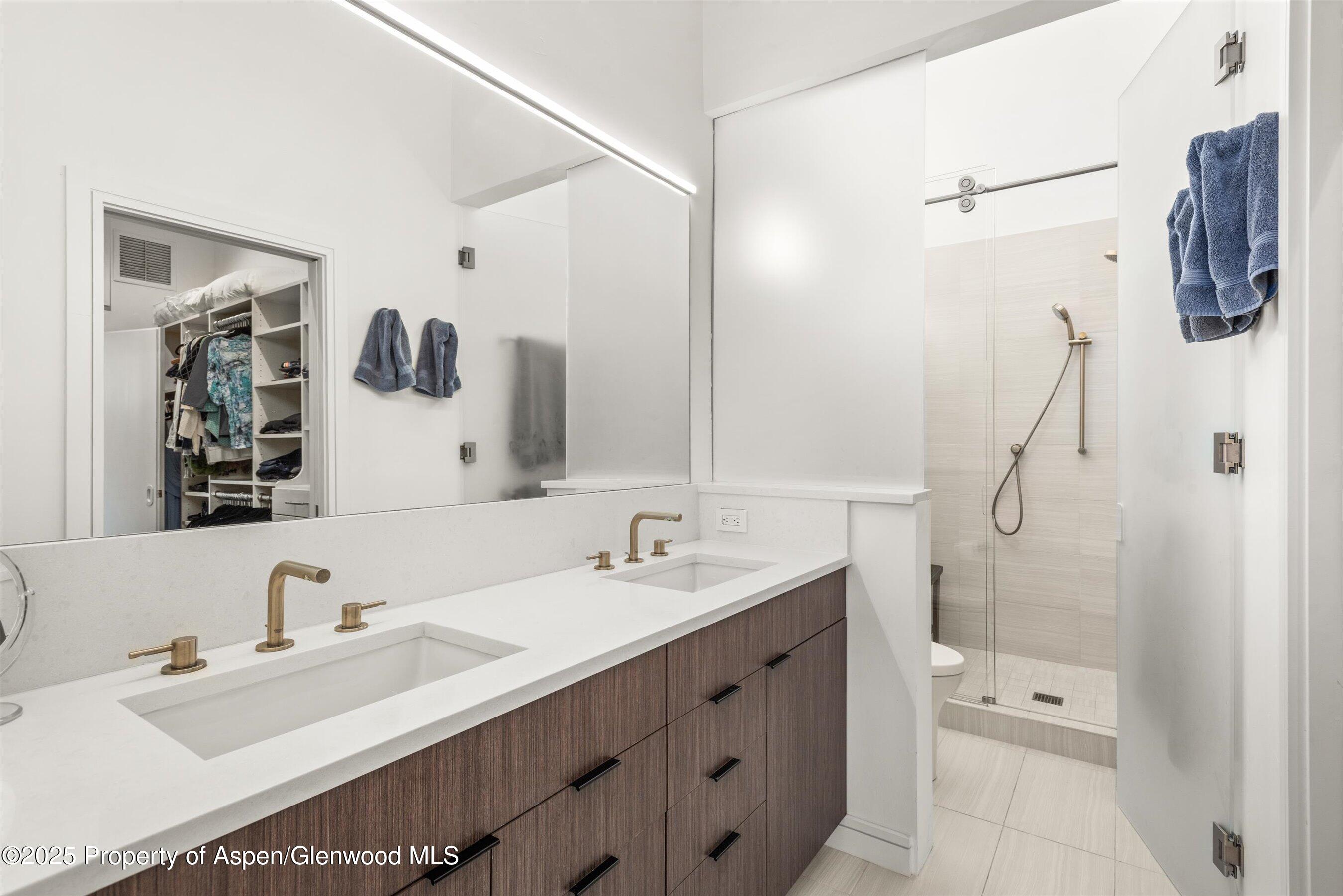 155 Lone Pine Road, Unit RIVER BLUFF #2 Aspen, CO 81611 - Photo 26 of 42 a bathroom with a double vanity sink mirror and double