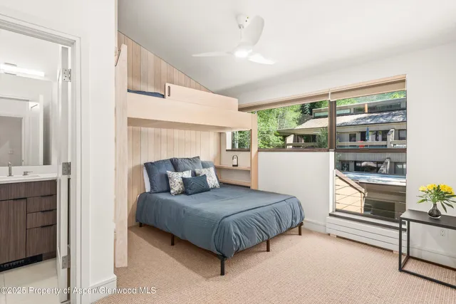 a bedroom with a large bed and a chandelier