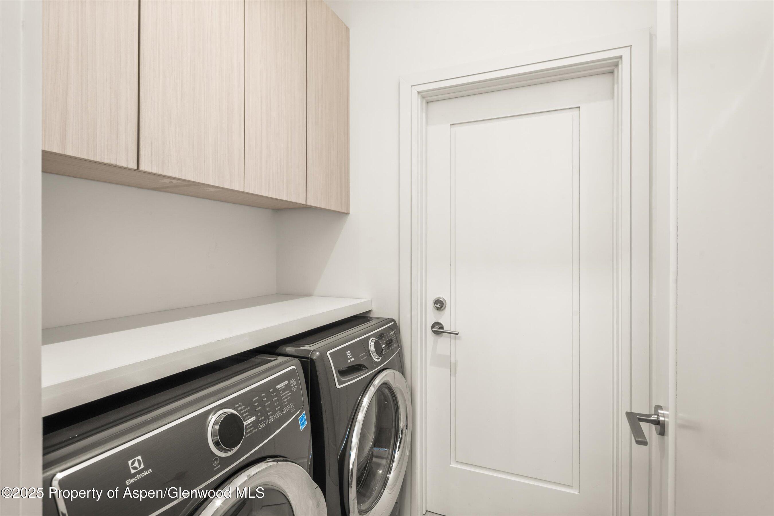 155 Lone Pine Road, Unit RIVER BLUFF #2 Aspen, CO 81611 - Photo 34 of 42 a utility room with dryer and washer