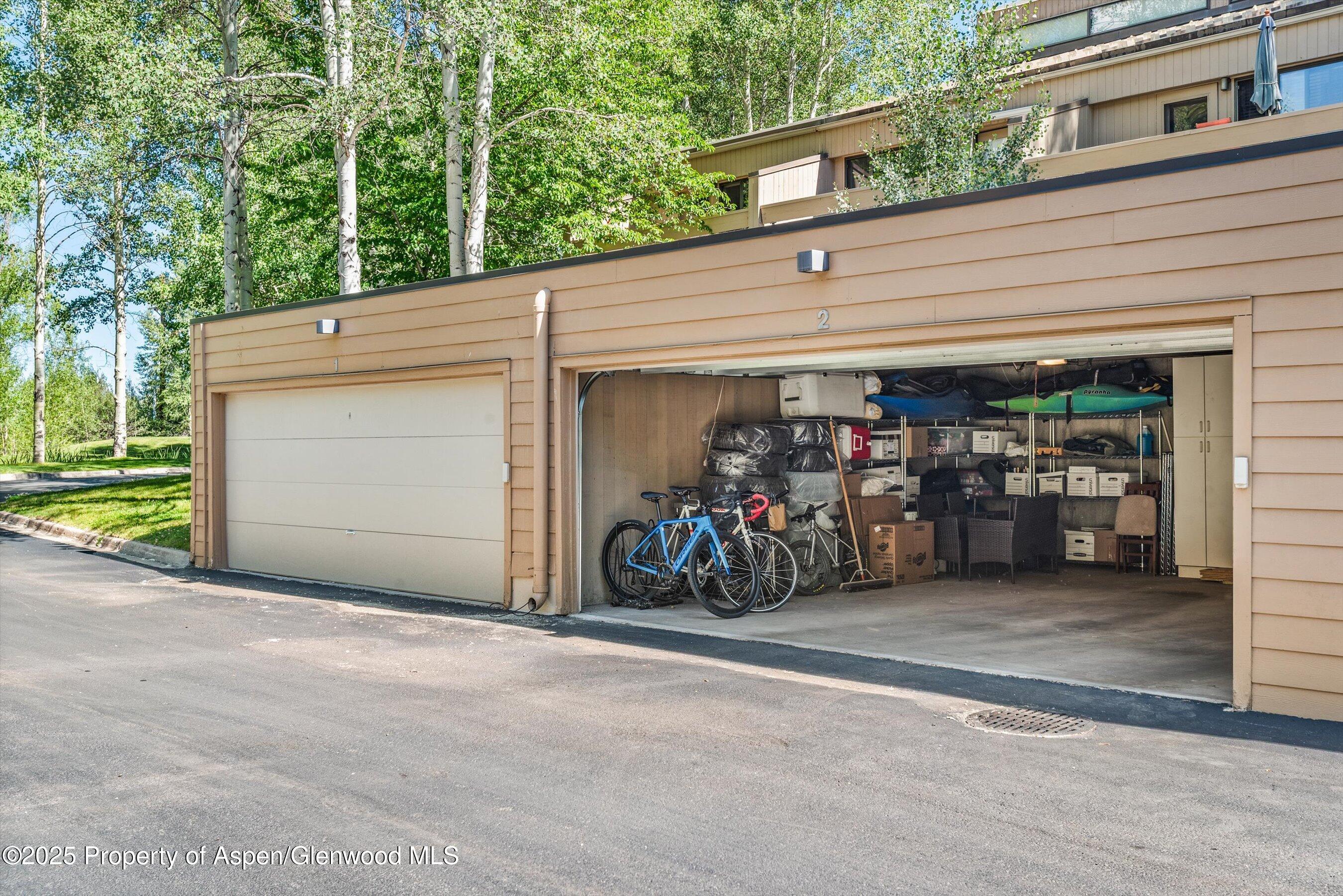 155 Lone Pine Road, Unit RIVER BLUFF #2 Aspen, CO 81611 - Photo 36 of 42 a view of a garage with parked cars
