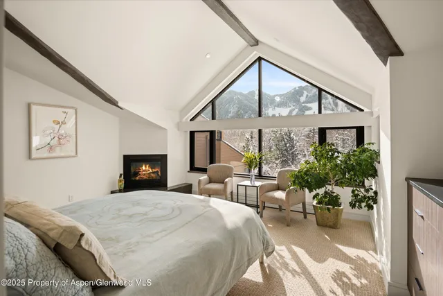 a spacious bedroom with a large bed and a large window