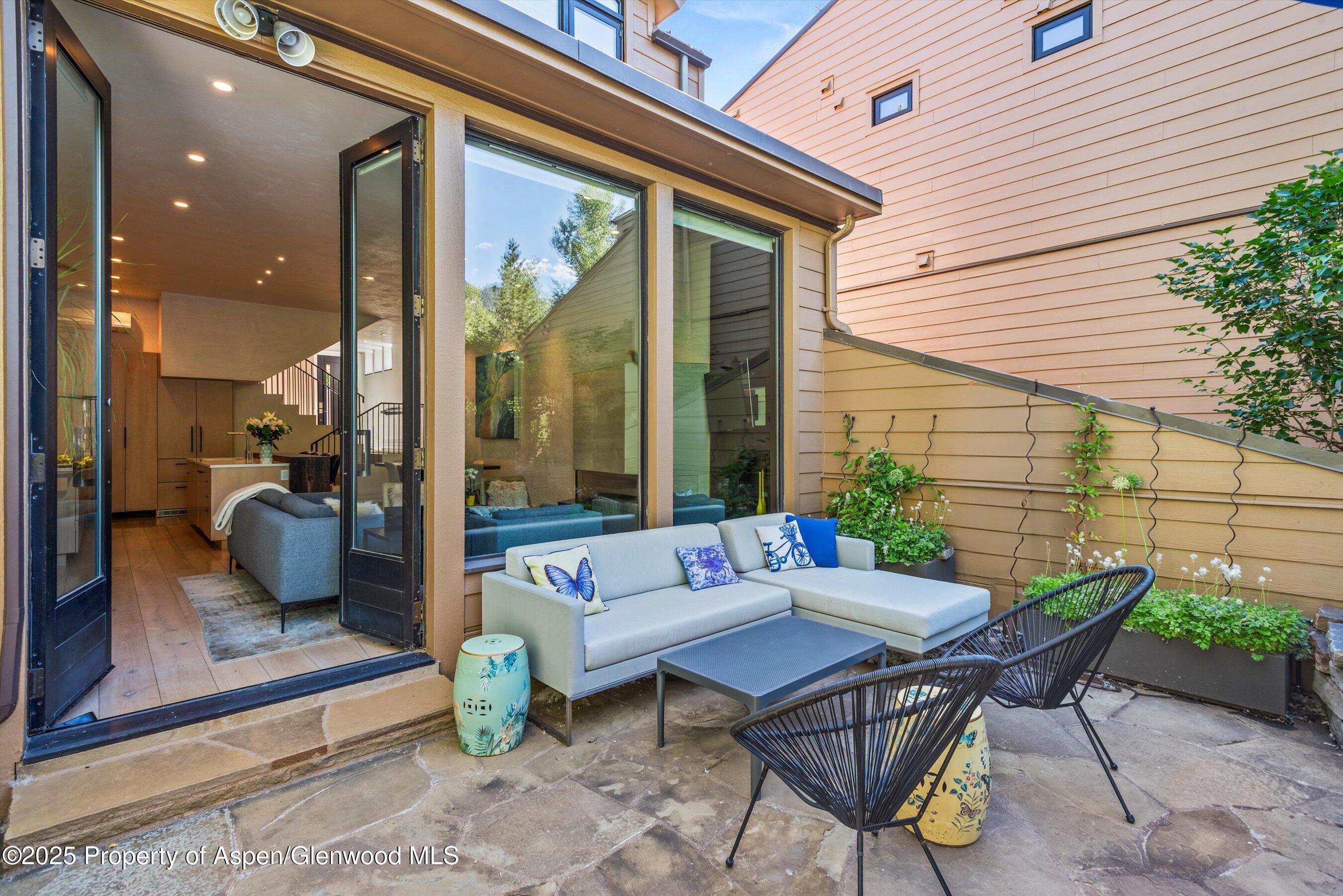 155 Lone Pine Road, Unit RIVER BLUFF #2 Aspen, CO 81611 - Photo 8 of 42 a outdoor space with patio furniture and a potted plant