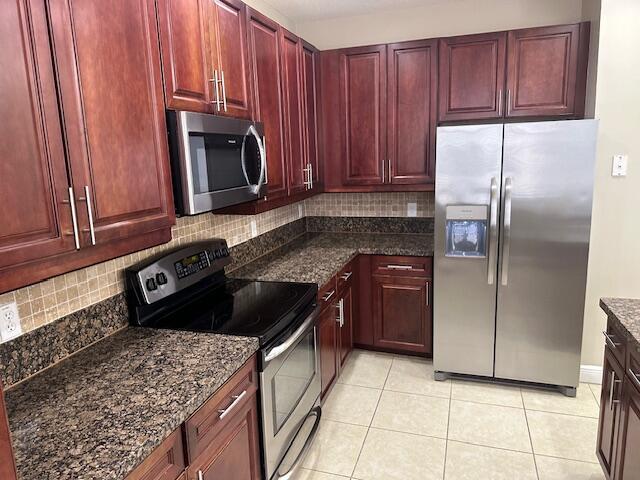 3608 Northwest 5th Terrace Boca Raton, FL 33431 - Photo 12 of 31 a kitchen with a stove microwave and refrigerator
