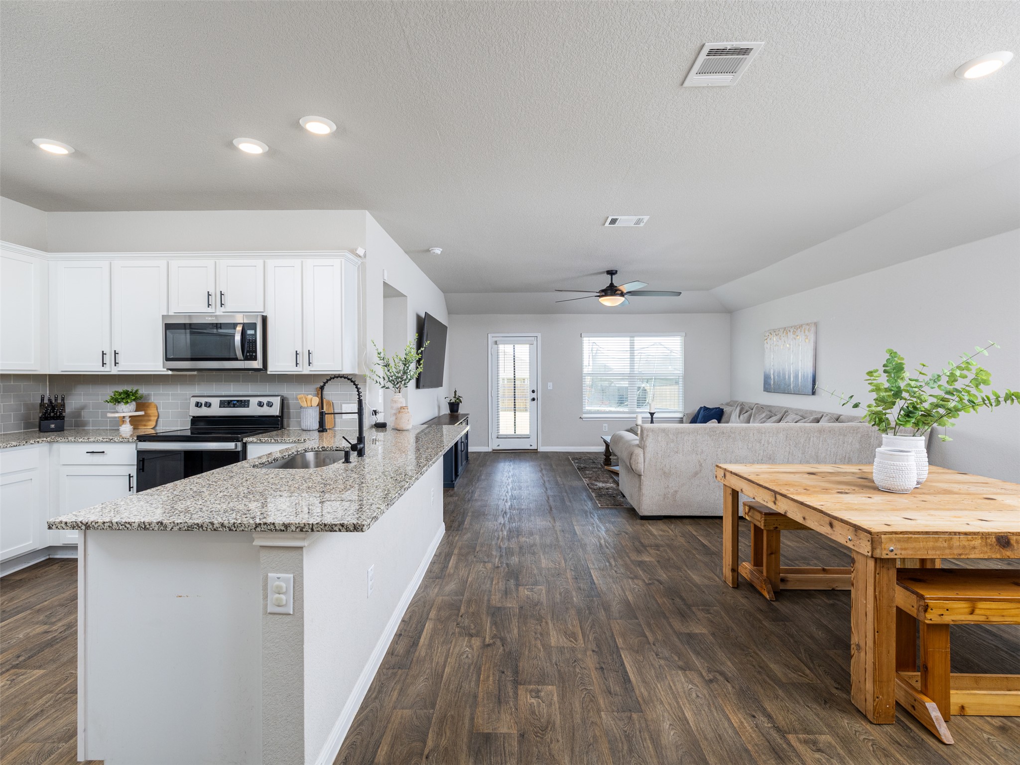 439 Hunter Loop Bertram, TX 78605 - Photo 4 of 23 An open concept design seamlessly connects the culinary space to the living area.