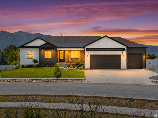 3111 South 1250 West Logan, UT 84321 - Photo 1 of 51 Modern ranch-style exterior featuring a striking blend of white vertical siding and dark horizontal siding