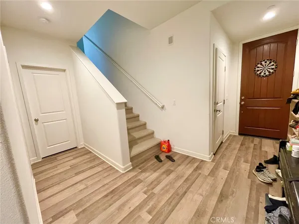 a view of a livingroom with wooden floor and stairs