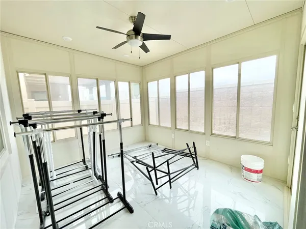 a view of a livingroom with furniture hardwood floor and a ceiling fan