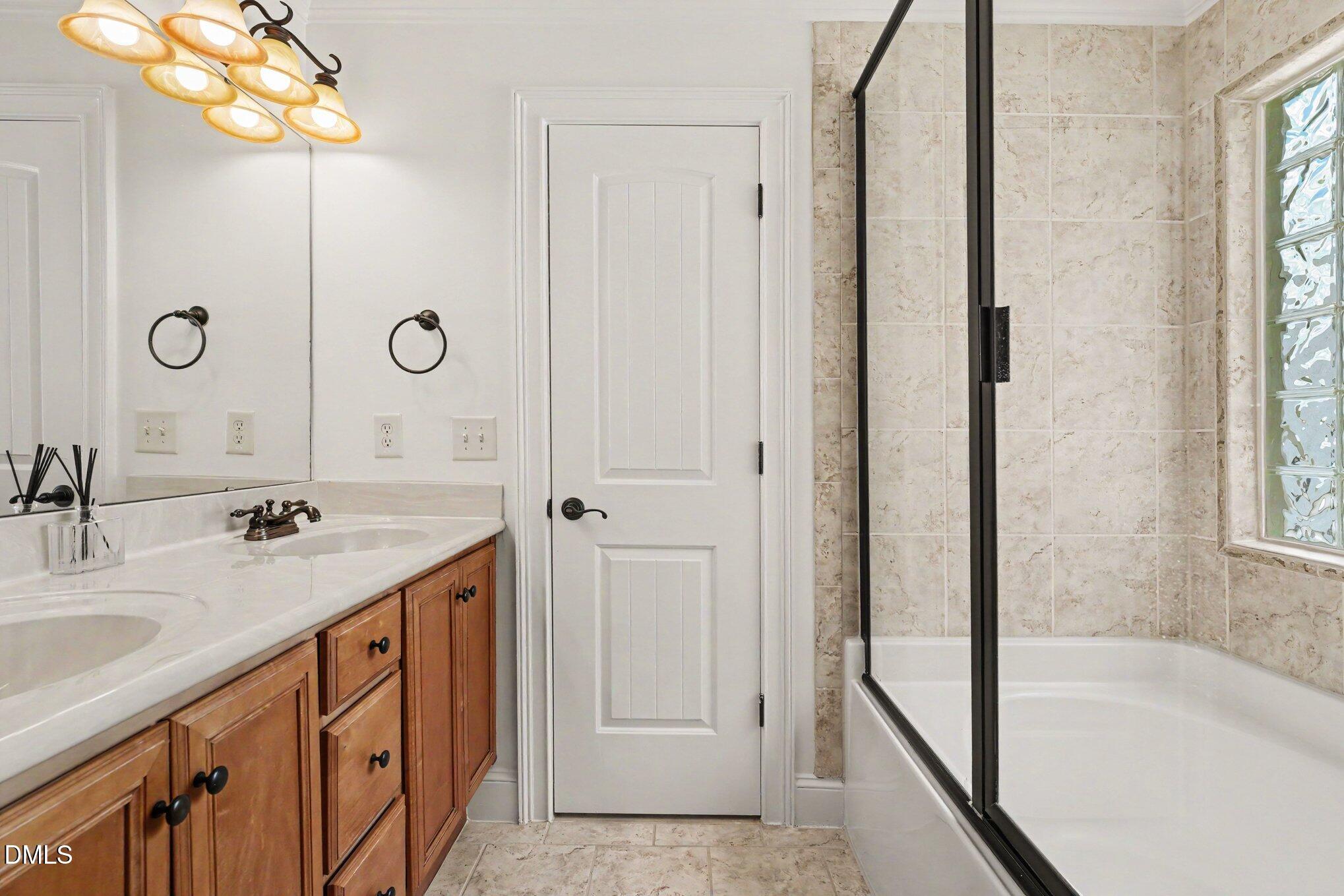 1729 Frenchwood Drive Raleigh, NC 27612 - Photo 31 of 46 a bathroom with a sink a vanity and a mirror