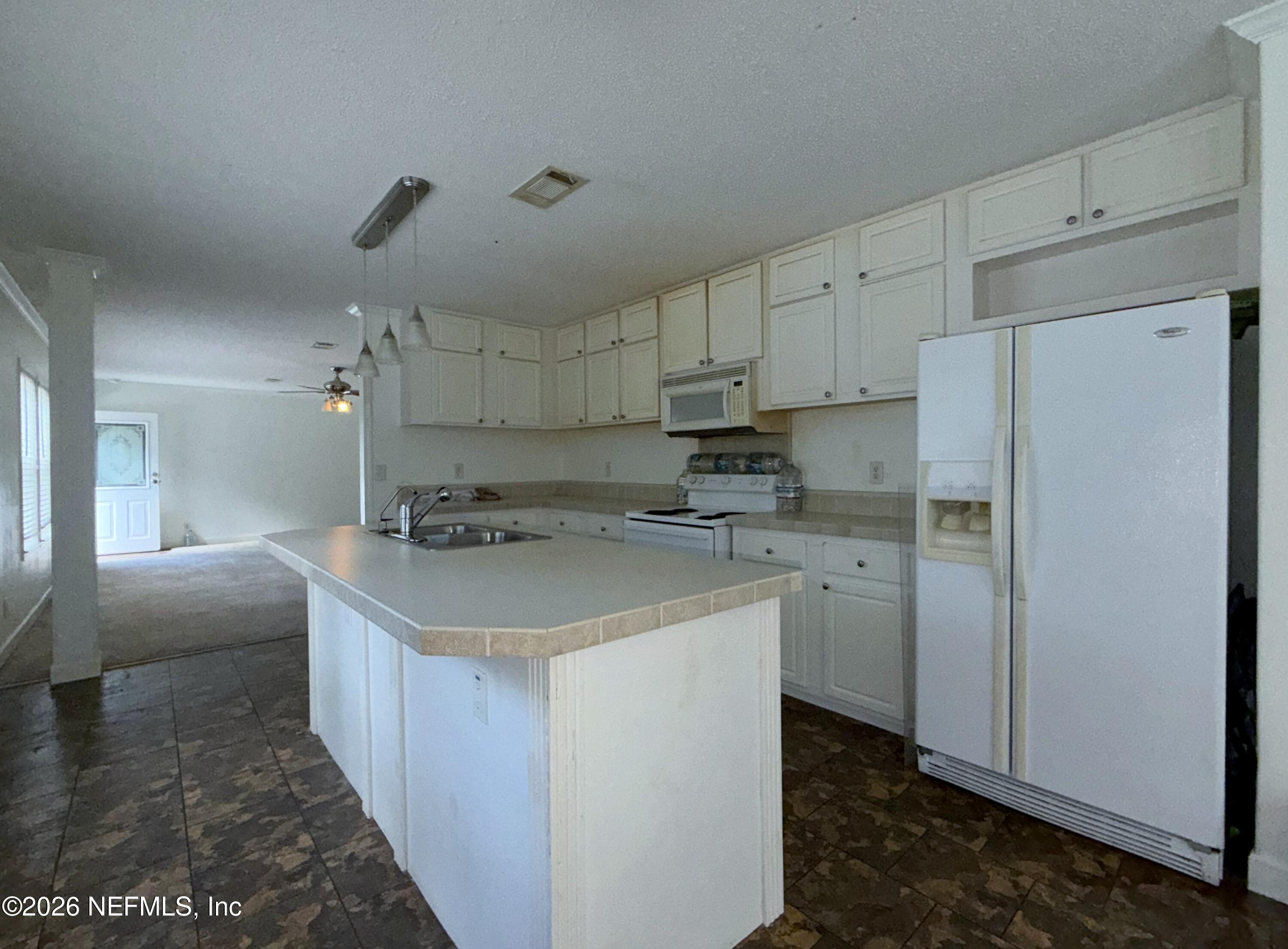 136 Short Pine Road Hawthorne, FL 32640 - Photo 16 of 39 a kitchen with stainless steel appliances a sink stove refrigerator and cabinets
