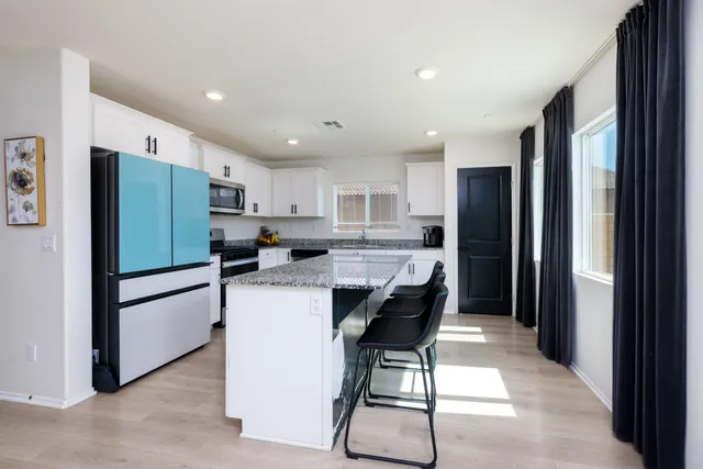 a dining room with furniture and a kitchen view