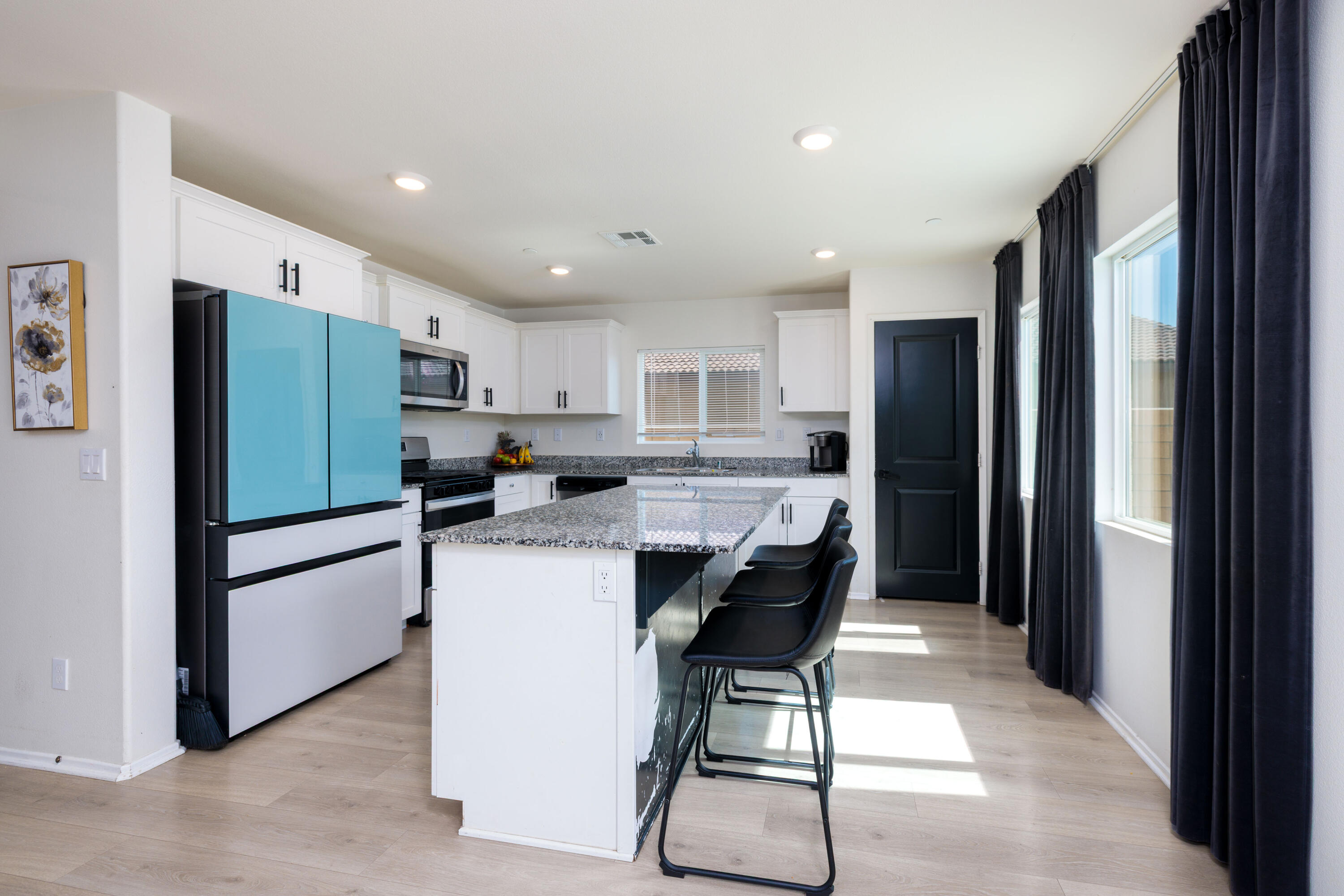 50187 Camino Rosario Coachella, CA 92236 - Photo 5 of 25 a kitchen with stainless steel appliances a refrigerator and a stove top oven