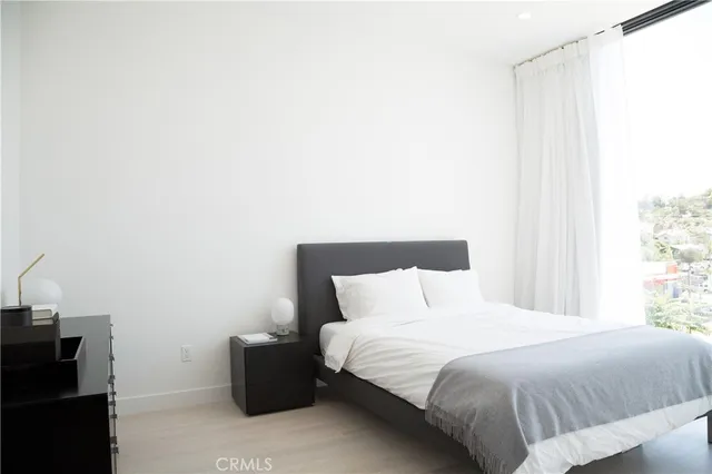 a bedroom with a bed and a window