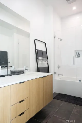 a bathroom with a tub sink and mirror