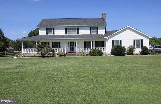 a front view of a house with a yard table and chairs