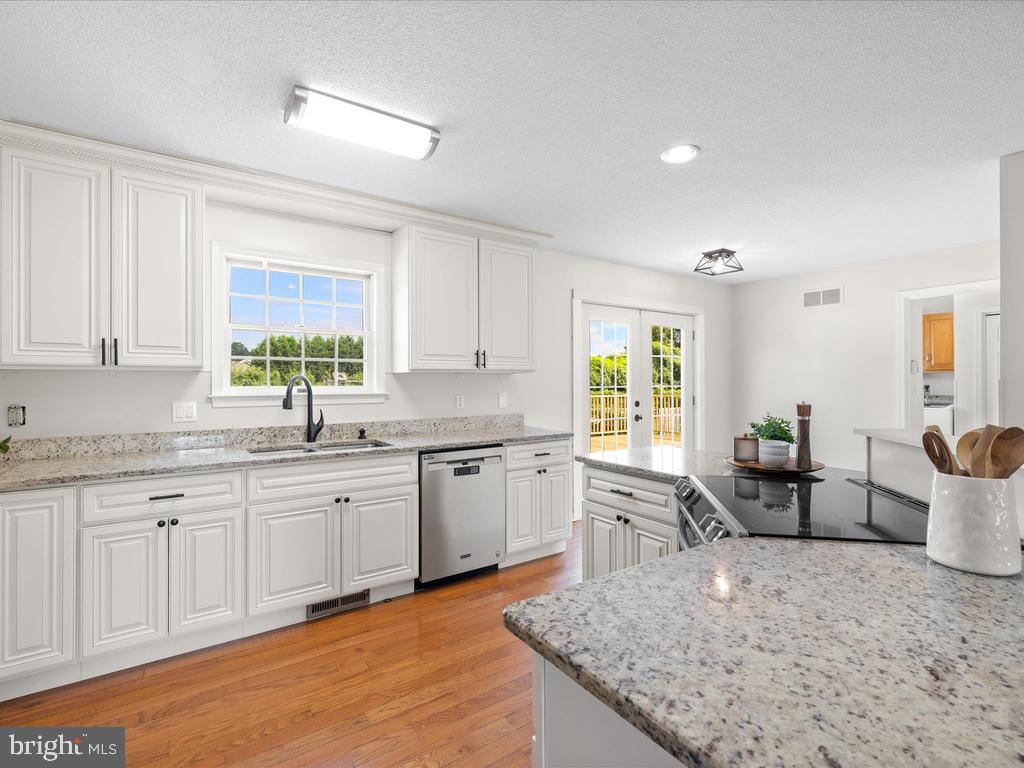 991 Church Hill Road Milford, DE 19963 - Photo 11 of 38 a kitchen with sink cabinets and wooden floor