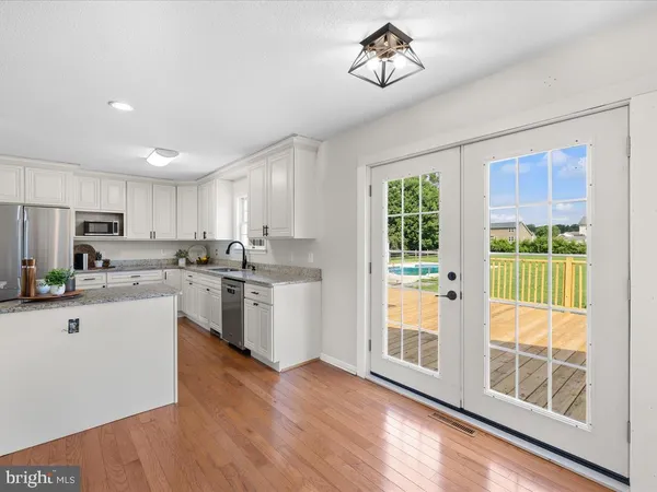 a kitchen with a sink appliances and cabinets