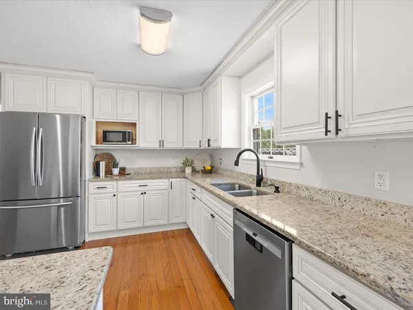 a kitchen with stainless steel appliances granite countertop a stove and a sink