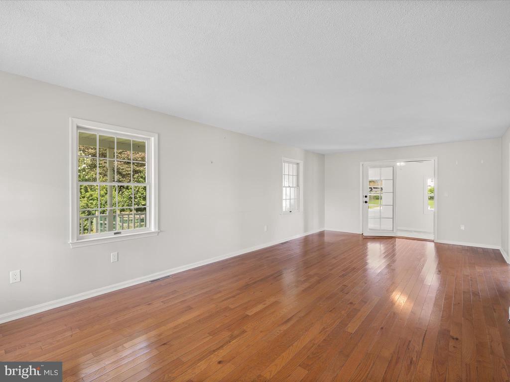 991 Church Hill Road Milford, DE 19963 - Photo 21 of 38 an empty room with wooden floor and windows