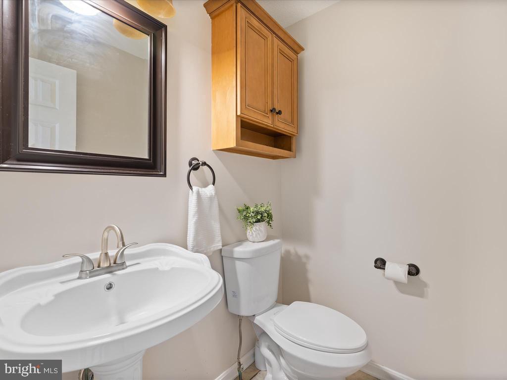 991 Church Hill Road Milford, DE 19963 - Photo 23 of 38 a bathroom with a toilet a sink and mirror