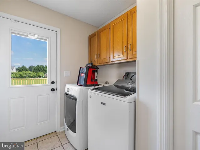 a bedroom with a bed couches and window