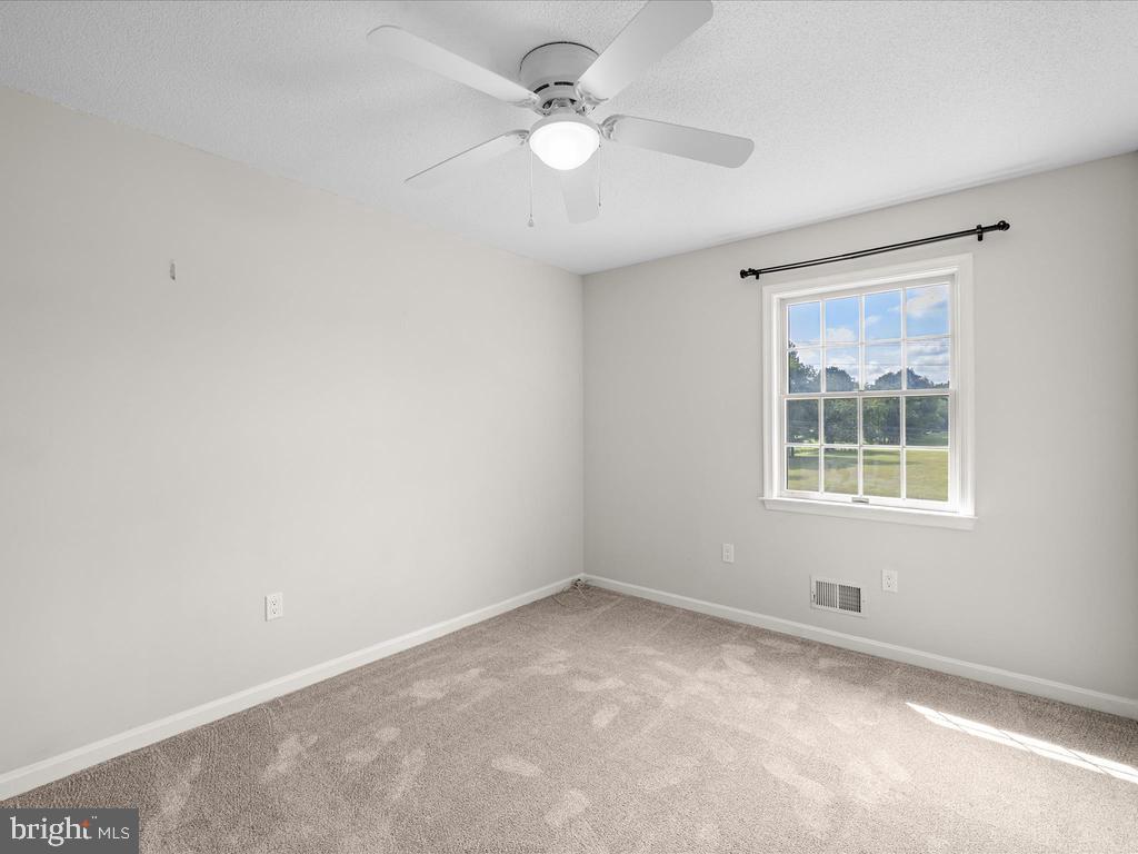 991 Church Hill Road Milford, DE 19963 - Photo 30 of 38 an empty room with a window and a fan