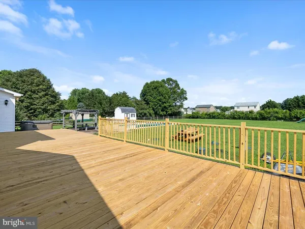 a view of balcony with wooden floor and fence