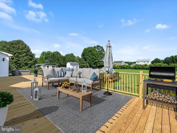 a view of a house with a big yard and a large tree