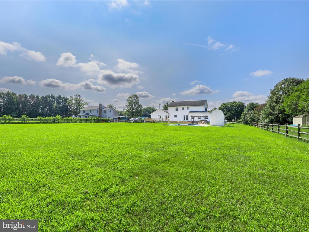 991 Church Hill Road Milford, DE 19963 - Photo 10 of 38 a view of a house with a big yard and a large tree