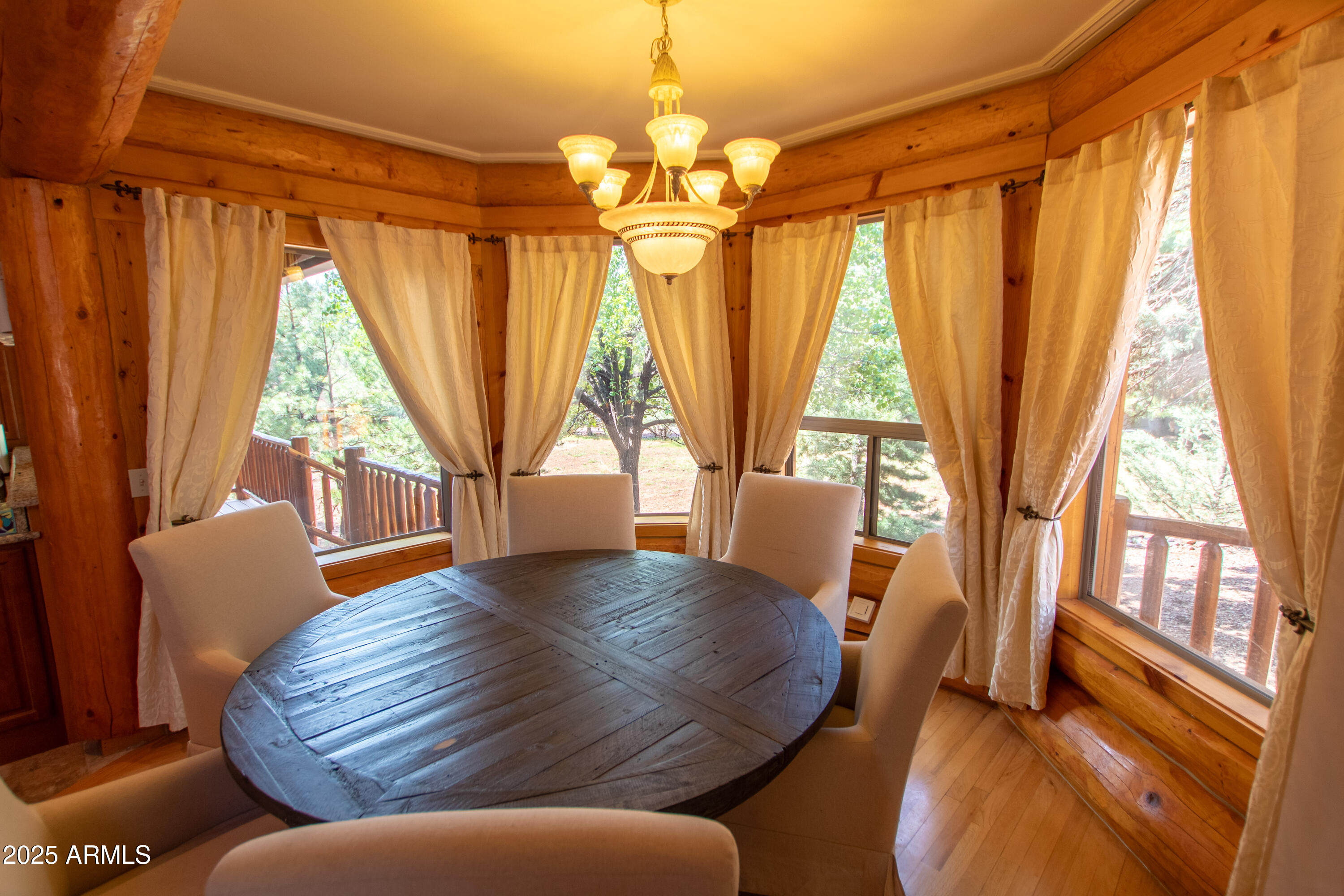 6168 Hidden Pines Loop Pine, AZ 85544 - Photo 14 of 77 a living room with large window and wooden floor