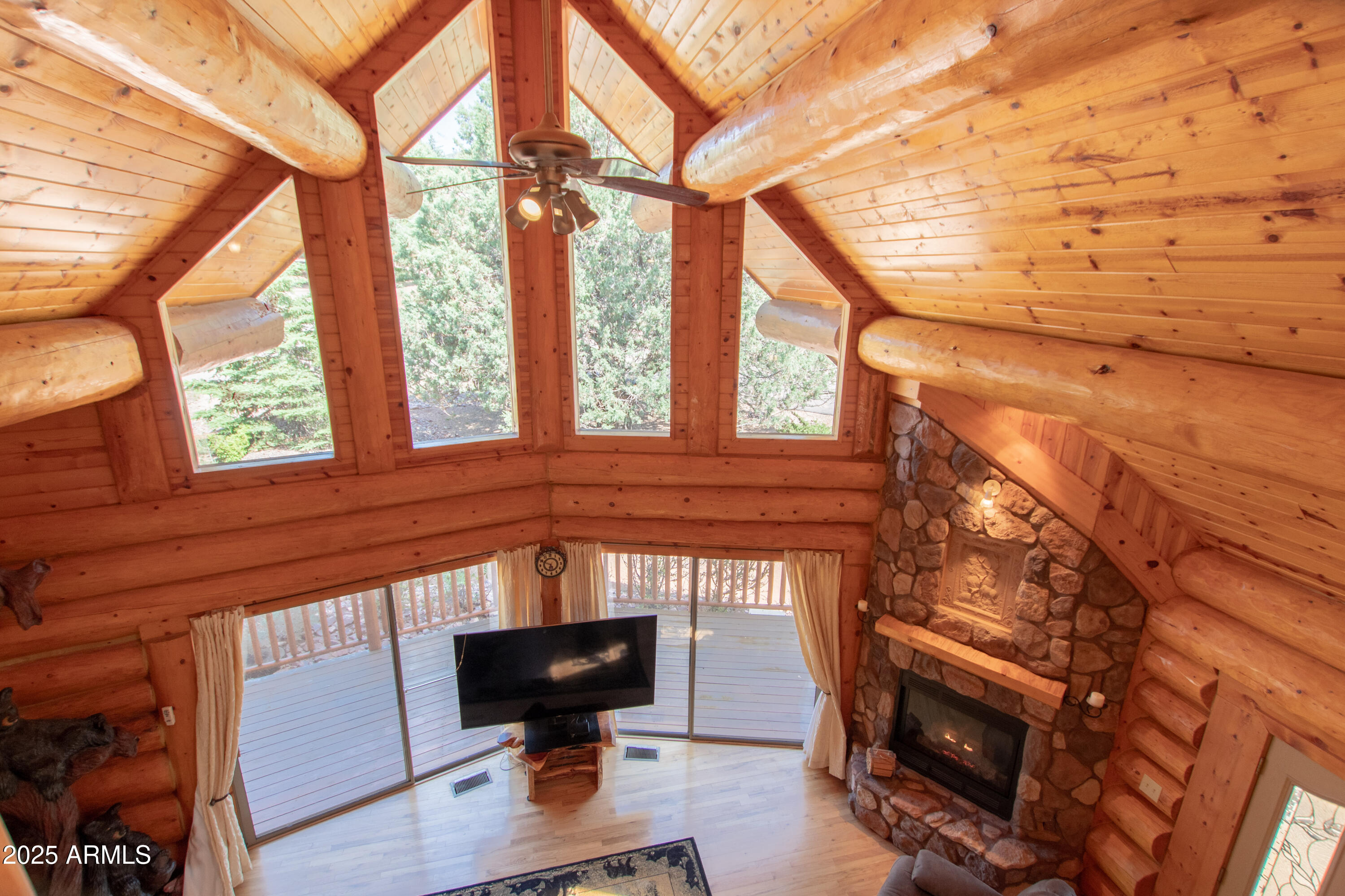 6168 Hidden Pines Loop Pine, AZ 85544 - Photo 31 of 77 a view of an empty room with wooden floor and a window