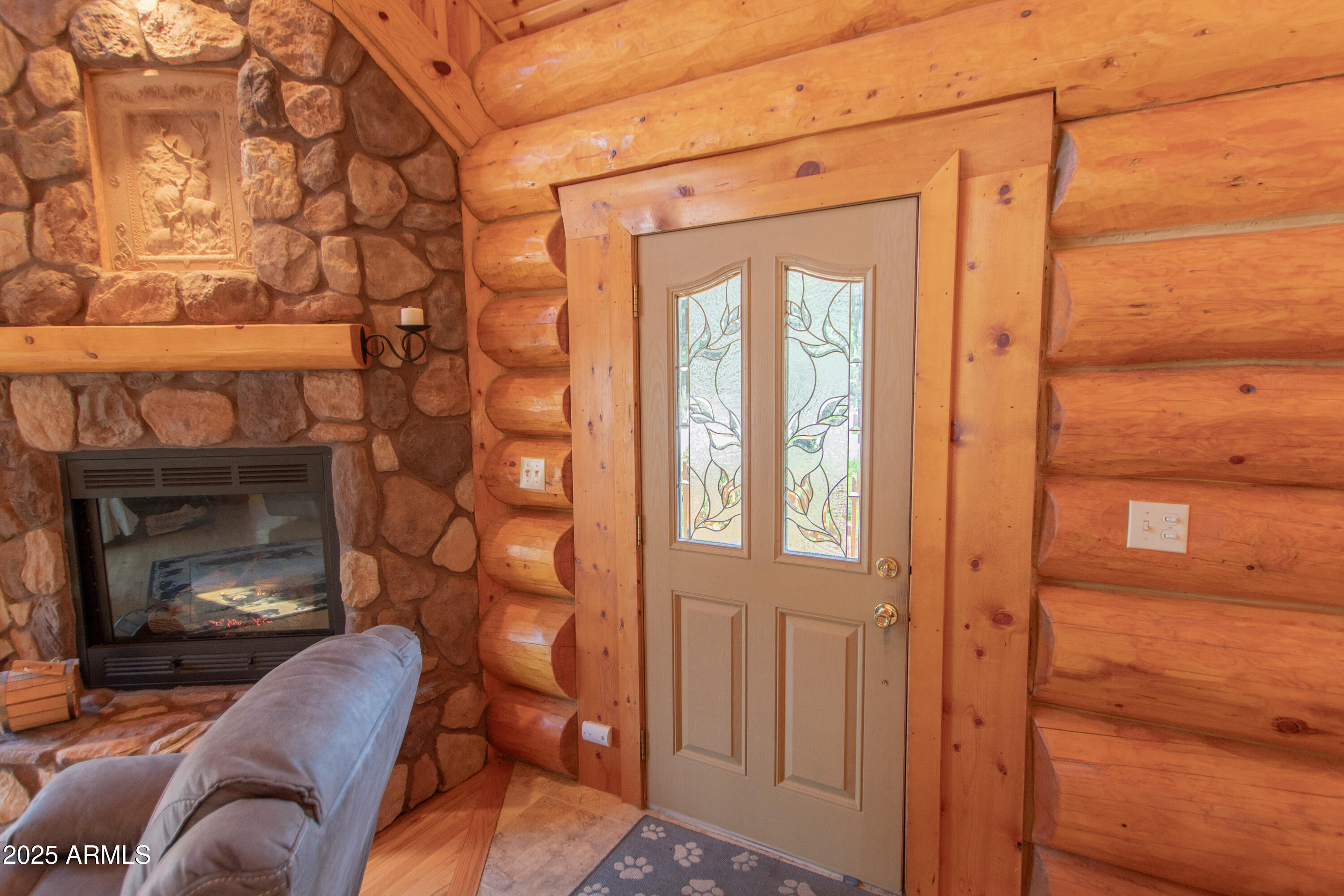 6168 Hidden Pines Loop Pine, AZ 85544 - Photo 36 of 77 a living room with furniture a fireplace and a floor to ceiling window
