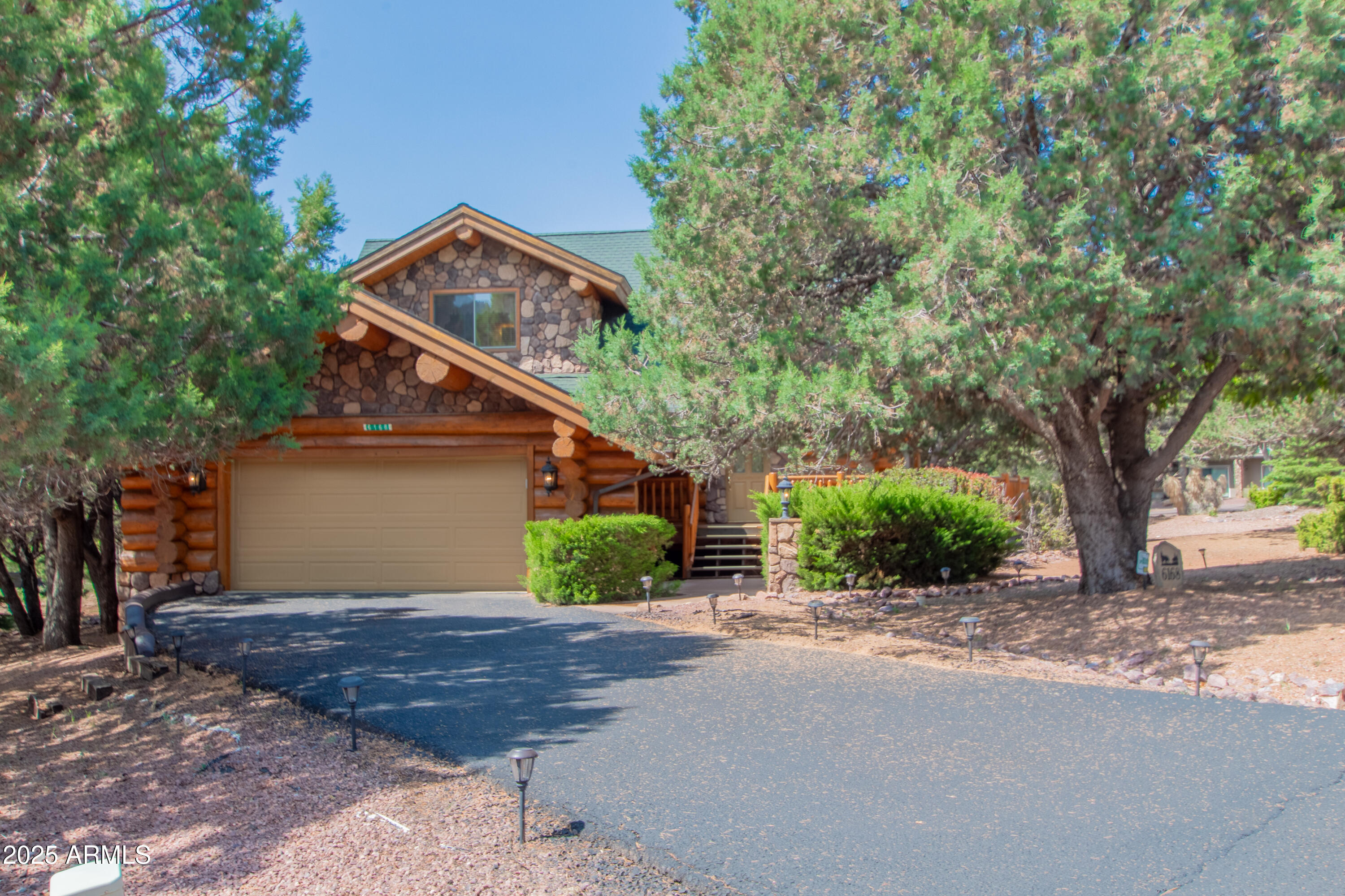 6168 Hidden Pines Loop Pine, AZ 85544 - Photo 46 of 77 a front view of a house with a yard and garage