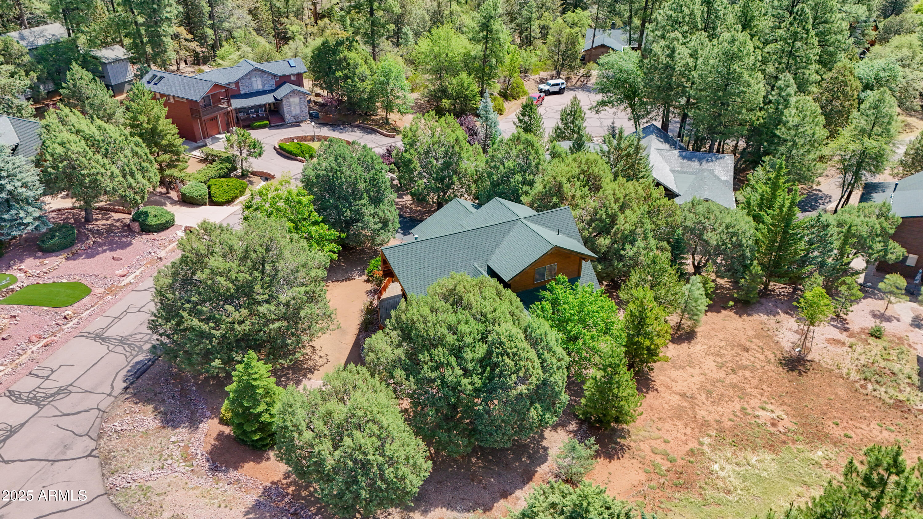 6168 Hidden Pines Loop Pine, AZ 85544 - Photo 62 of 77 an aerial view of a house with a yard