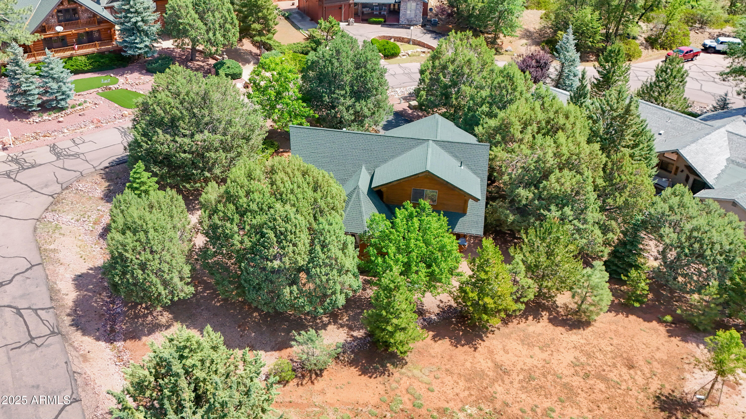 6168 Hidden Pines Loop Pine, AZ 85544 - Photo 63 of 77 an aerial view of a house with a yard and garden