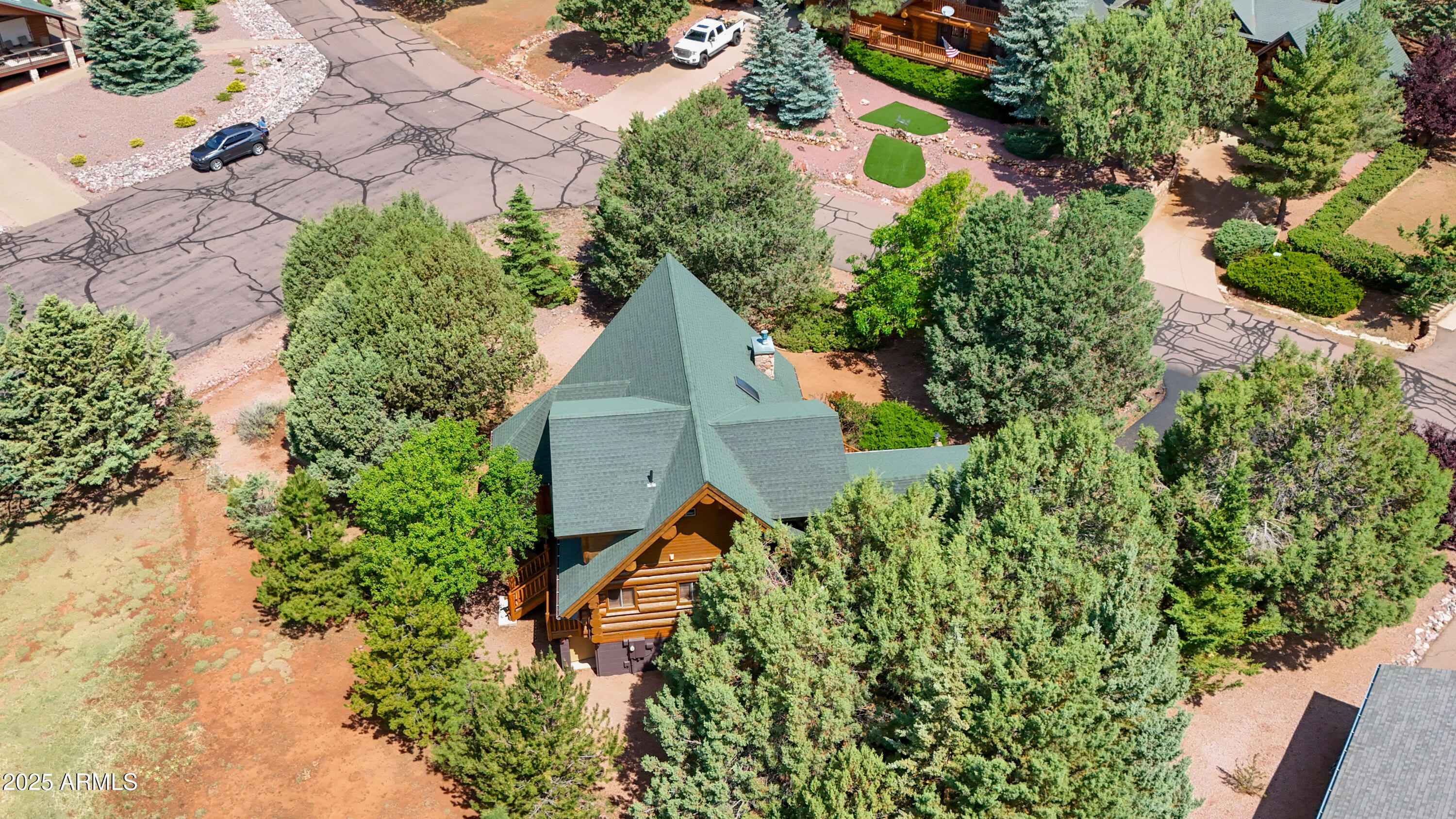 6168 Hidden Pines Loop Pine, AZ 85544 - Photo 66 of 77 an aerial view of a house with a yard and garden