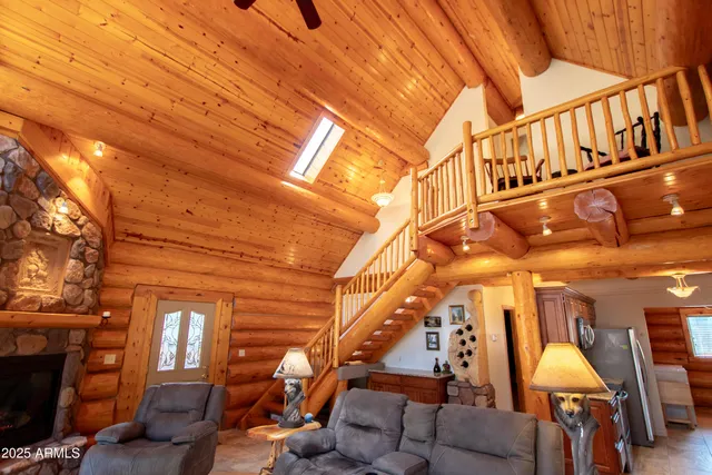 a living room with large window and wooden floor