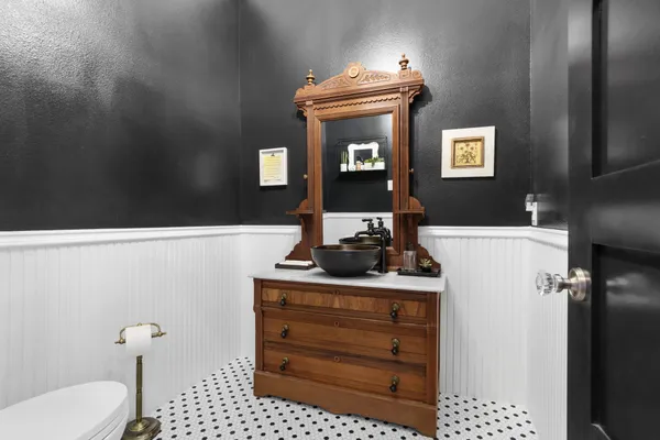 a bathroom with a sink a toilet and mirror