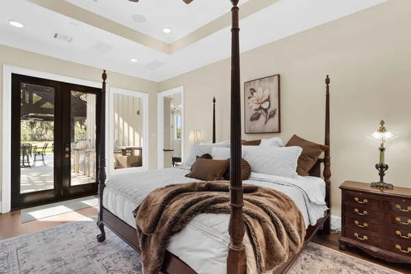 a bedroom with a large bed and a night stand