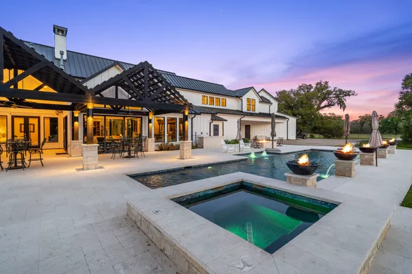 a view of a house with backyard porch and sitting area