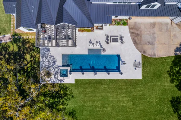 an aerial view of residential house with outdoor space and swimming pool