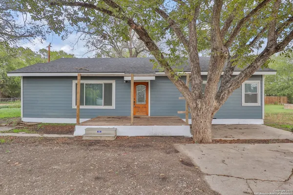 a house that has a tree in front of the house