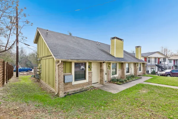 a front view of a house with a yard table and chairs