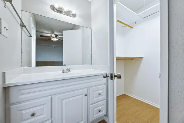 a bathroom with a granite countertop sink mirror and vanity